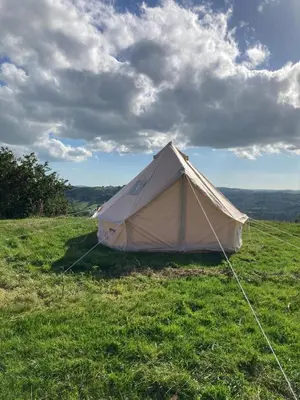 a white tent sitting on top of a field at Fair View Bell Tent in Oswestry