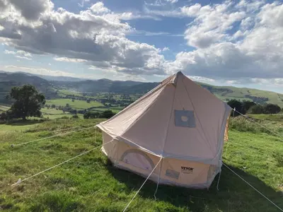 a white tent sitting on top of a field at Fair View Bell Tent in Oswestry