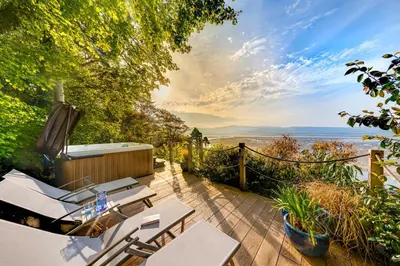 a patio with chairs and a view of the ocean at 5 Bed in Aberdovey oc-t29402 in Aberdyfi