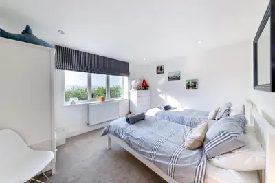 a bedroom with two beds and a window at 5 Bed in Aberdovey oc-t29402 in Aberdyfi