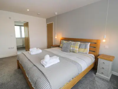 a bedroom with a bed with two towels on it at Melin Y Plas in Barmouth