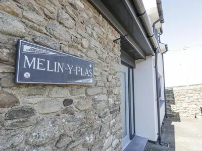a sign on the side of a building at Melin Y Plas in Barmouth