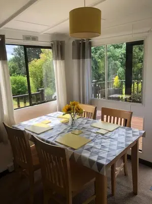 a dining room table with chairs and a blue table cloth at 5f Stanley Lodge, Caer Beris, Builth Wells - No tradesman in Builth Wells