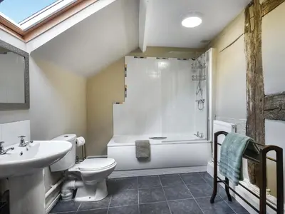 a bathroom with a sink and a toilet and a shower at Ty-Ucha Cottage in Llangollen