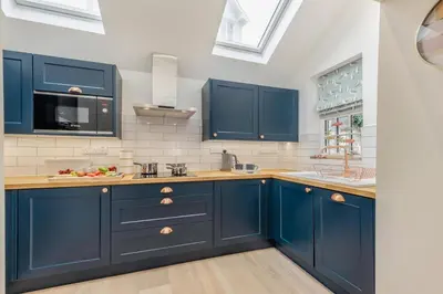 a kitchen with blue cabinets and a sink at 3 Bed in New Quay oc-c29640 in New Quay