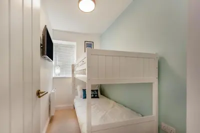 a white bunk bed with a staircase in a room at 3 Bed in New Quay oc-c29640 in New Quay