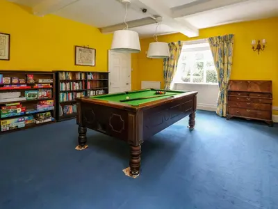 a billiard table in a room with yellow walls at New Hall in Wrexham