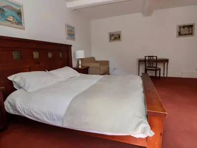 a bedroom with a large bed and a desk at New Hall in Wrexham