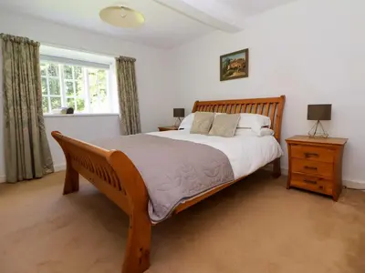 a bedroom with a large bed and a window at New Hall in Wrexham
