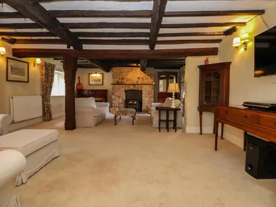 a living room with a couch and a fireplace at New Hall in Wrexham