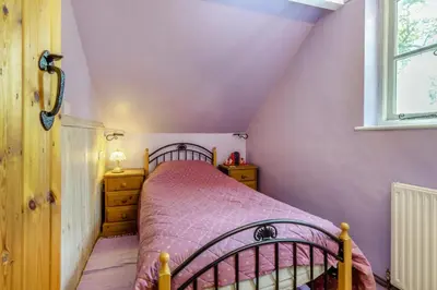 a small bedroom with a bed and a window at 3 Bed in Llwynygroes oc-t29715 in Llangeitho