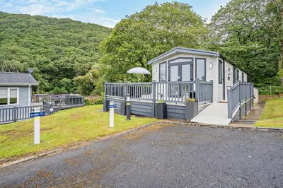 a tiny house with a porch and a driveway at 2 Bed in Gilfachrheda oc-o29754 in Llanina