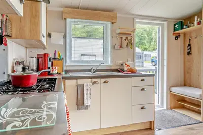 a small kitchen with a stove and a sink at 2 Bed in Gilfachrheda oc-o29754 in Llanina