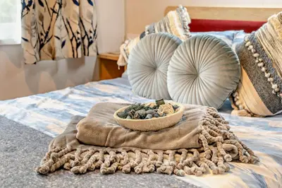 a bowl of rocks on a bed with pillows at 2 Bed in Gilfachrheda oc-o29754 in Llanina