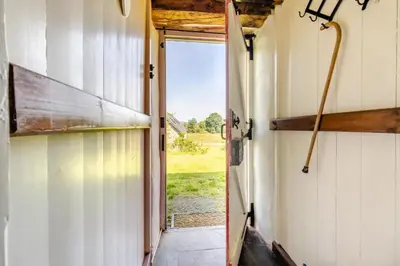 an open door to a barn with a view of a field at 4 Bed in Llwynygroes oc-y29715 in Llangeitho
