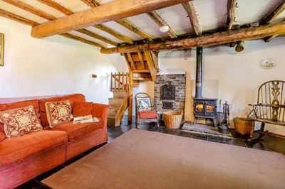 a living room with a couch and a fireplace at 4 Bed in Llwynygroes oc-y29715 in Llangeitho