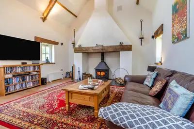 a living room with a couch and a fireplace at 4 Bed in Llwynygroes oc-y29715 in Llangeitho