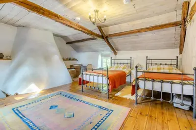 a bedroom with two beds and a rug on the floor at 4 Bed in Llwynygroes oc-y29715 in Llangeitho