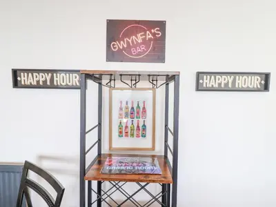 a table with a sign that reads happy hour at Gwynfa in Barmouth