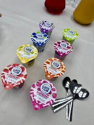 a group of cupcake wrappers on a table with scissors at Cross Hands Hotel in Llanybydder