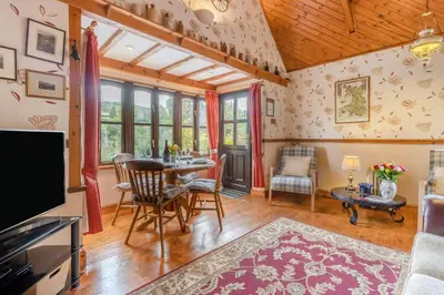 a living room with a table and chairs and a tv at 2 Bed in Devils Bridge oc-d29575 in Devils Bridge