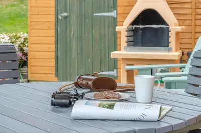a table with a camera and a bag and a cup at 2 Bed in Devils Bridge oc-d29575 in Devils Bridge