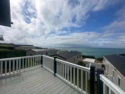 a balcony with a view of the ocean at WH - Smugglers Lodge in Aberaeron