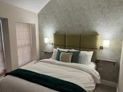 a bedroom with a large white bed with two lamps at Class Stays in Shrewsbury