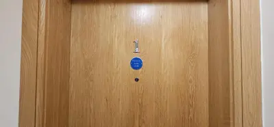 a wooden door with a blue sticker on it at Class Stays in Shrewsbury