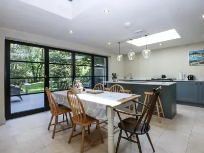 a kitchen with a white table and chairs in a kitchen at Islwyn in Bala