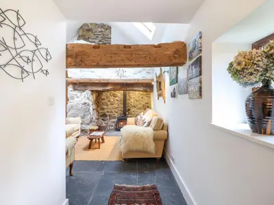 a view of a living room with a stone fireplace at Ty Newydd Uchaf in Dolgellau