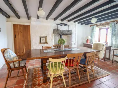 a dining room with a wooden table and chairs at Ty Newydd Uchaf in Dolgellau