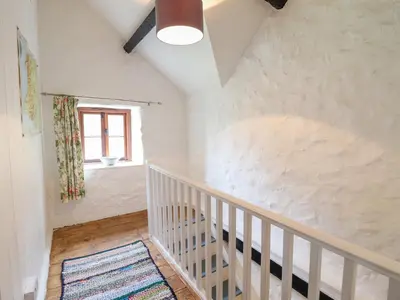 a staircase in a house with a window at Ty Newydd Uchaf in Dolgellau
