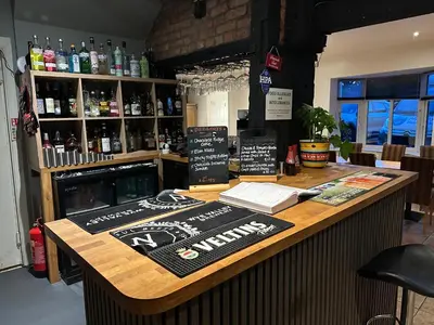 a bar with a sign on the counter at The Boughton Peterchurch - Pub Grub & Bed in Peterchurch