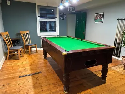 a room with a pool table and two chairs at The Boughton Peterchurch - Pub Grub & Bed in Peterchurch