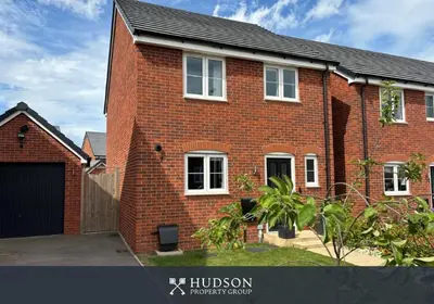 a red brick house with a black garage at 3 Bedroom Modern Property with Parking in Shrewsbury