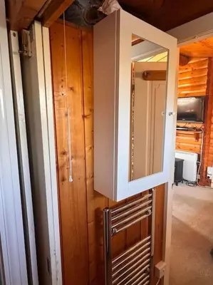 a room with a door and a mirror on a wall at Gwel-y-Cwm - Valley View in Trawsfynydd