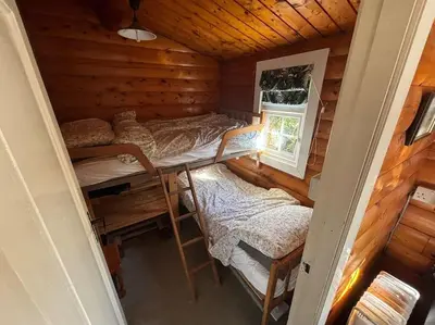 a room with two bunk beds and a window at Gwel-y-Cwm - Valley View in Trawsfynydd