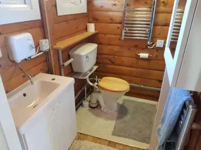 a small bathroom with a toilet and a sink at Gwel-y-Cwm - Valley View in Trawsfynydd