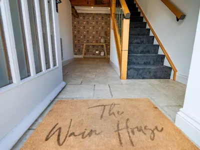 a welcome mat in front of a door with the winter fire written on it at Countryside home 5 minutes from Ludlow - Pass the Keys in Ludlow