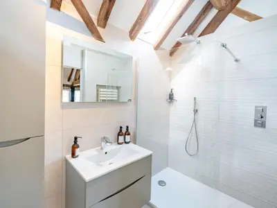 a white bathroom with a sink and a shower at Countryside home 5 minutes from Ludlow - Pass the Keys in Ludlow
