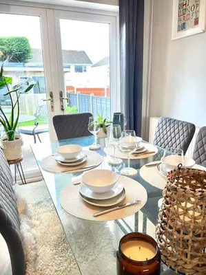 a dining room table with plates and glasses on it at Pet friendly, spacious house, sleeps 6 in Llanbadarn-fawr