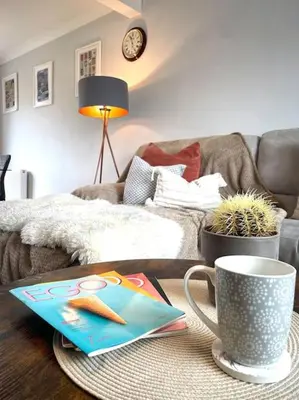 a coffee table in a living room with a coffee cup at Pet friendly, spacious house, sleeps 6 in Llanbadarn-fawr