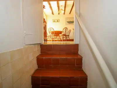 a staircase with a table and chairs in a room at Old Bricklayer's Arms in Bishops Castle