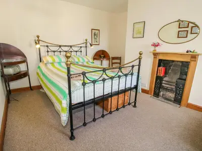a bedroom with a bed and a fireplace at Old Bricklayer's Arms in Bishops Castle