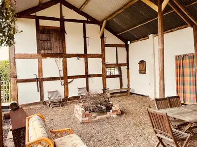 a pavilion with a table and chairs and a table at Tawny Owl Barn in Leintwardine