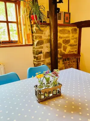 a blue polka dot table with a basket of flowers on it at Tawny Owl Barn in Leintwardine