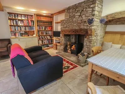 a living room with a couch and a fireplace at New Inn Cottage in Church Stretton