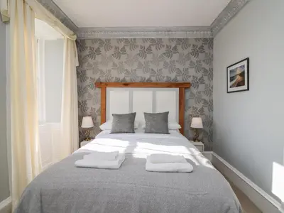a bedroom with a large bed with two pillows on it at Llwynderw Hall in Llanwrtyd Wells