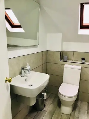 a bathroom with a sink and a toilet at Bell Cottage by Ludlow Castle with onsite parking in Ludlow